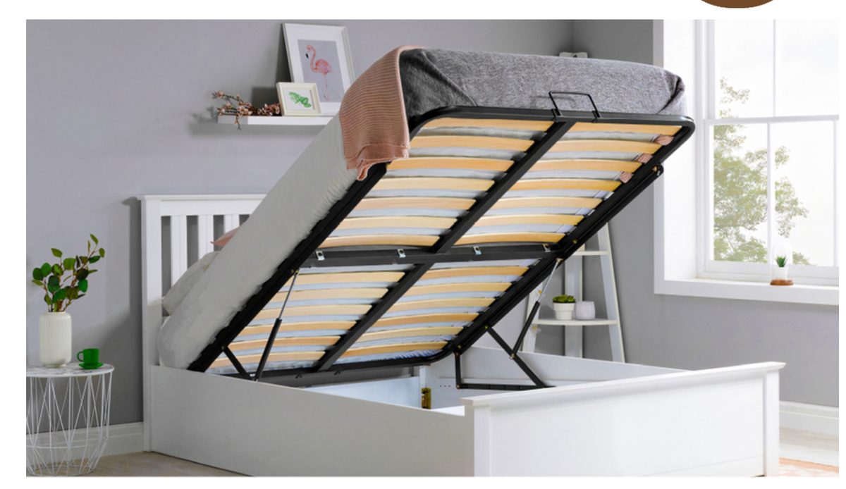 Bed with a hydraulic lift-up storage frame