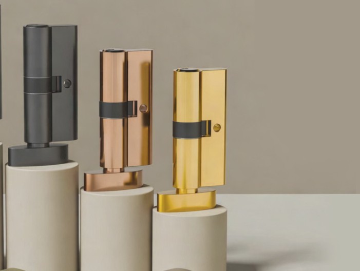 Brass, rose gold and graphite euro cylinder locks displayed with keys